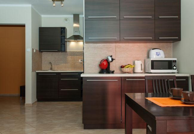 kitchen, table, chairs, microwave, toaster, kitchen cabinets