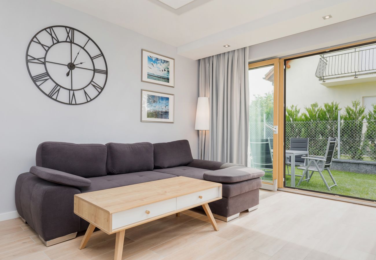  living room, clock, coffee table, sofa, window, outdoor view, rent 