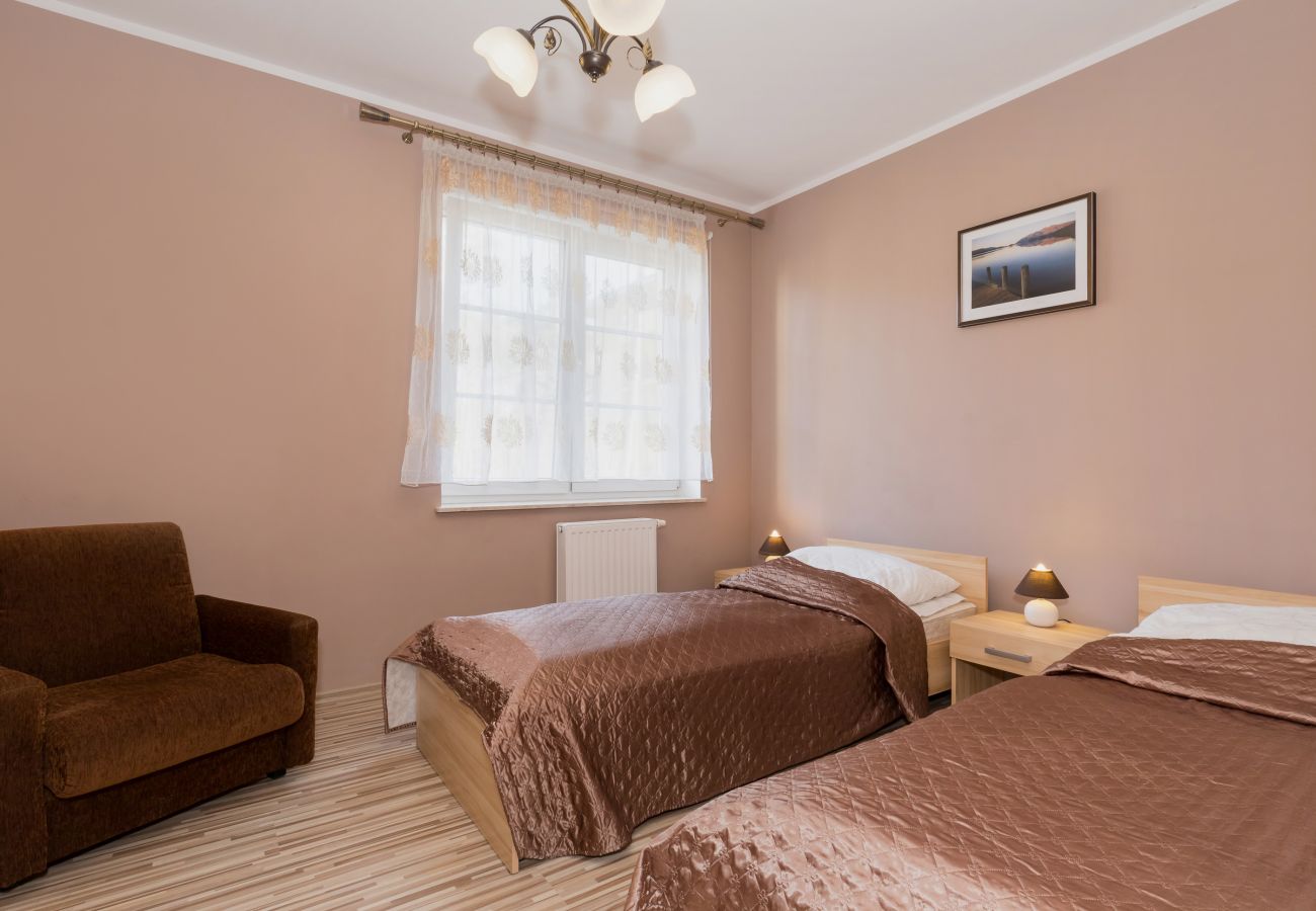 bedroom, single beds, nightstand, night lamp, armchair, window, pillows, blankets, rent