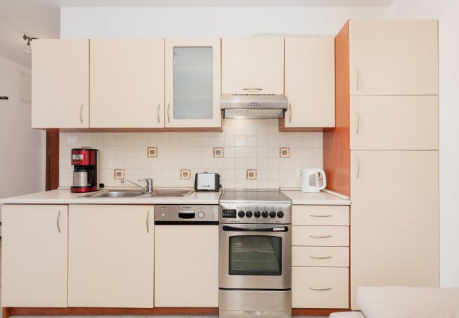 kitchen, kitchenette, coffee machine, stove, oven, kettle, toaster, dishwasher, cupboards, dining area, dining table, chairs, rent