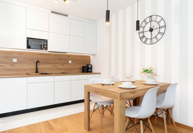 kitchen, kitchenette, dining area, dining table, chairs, stove, dishwasher, kettle, coffee maker, toaster, microwave, fridge, cupboards, apartment, in