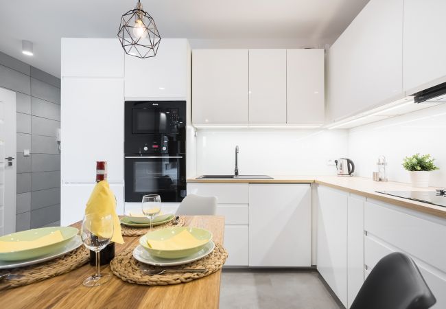 kitchen, kitchenette, dining area, dining table, chairs, stove, fridge freezer, dishwasher, oven, kettle, toaster, microwave, cupboards, apartment, in
