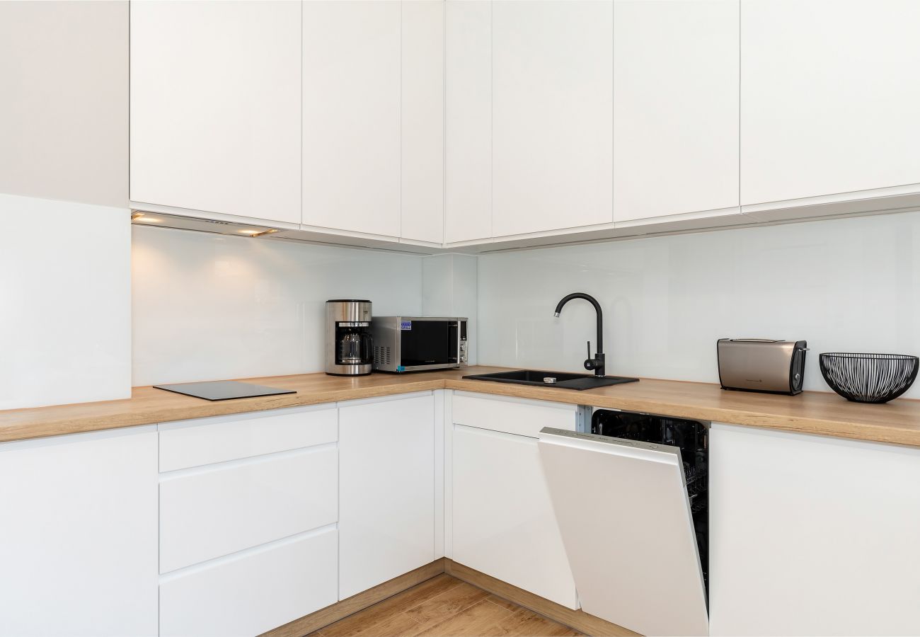kitchen, kitchenette, dining area, dining table, chairs, kettle, coffee maker, toaster, microwave, dishwasher, fridge freezer, cupboards, apartment, i