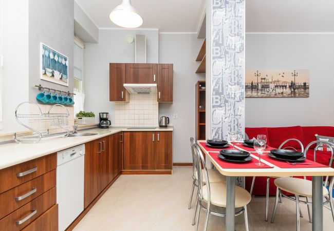 kitchen, kitchenette, electric hob, dishwasher, fridge freezer, kettle, coffee machine, microwave, toaster, cupboards, dining area, table, chairs, apa